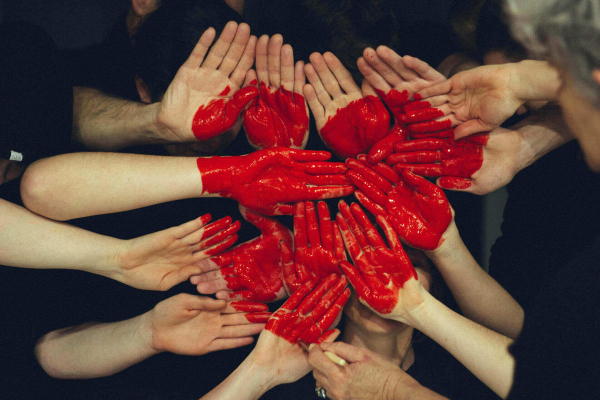 employee hands put together painted with big heart